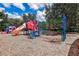 Community playground with colorful slides, climbing structures, and a cushioned ground surface for safety at 3624 Autumn Amber Dr, Spring Hill, FL 34609