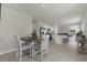 Open-concept dining area with a table and chairs adjacent to the kitchen and living spaces, perfect for gatherings at 3664 Zephyr Preserve Pl, Zephyrhills, FL 33541