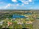 Beautiful aerial view of the community featuring a large lake surrounded by homes and lush greenery at 4110 Highland Park Cir, Lutz, FL 33558