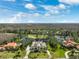 Beautiful home with a long drive, lush landscaping, and view of the golf course at 4110 Highland Park Cir, Lutz, FL 33558