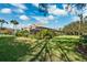 Spacious backyard featuring a manicured lawn, mature landscaping, and a screened-in patio, perfect for outdoor entertaining at 4110 Highland Park Cir, Lutz, FL 33558