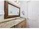 Bathroom with large mirror, granite countertop, vanity, and white colored walls at 4110 Highland Park Cir, Lutz, FL 33558