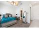 Bedroom with a silver bed frame, ceiling fan, neutral carpet, and a mirrored dresser leading to a bathroom at 4110 Highland Park Cir, Lutz, FL 33558