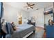 Bedroom with neutral colored walls, ceiling fan, wood floors, and ensuite bathroom at 4110 Highland Park Cir, Lutz, FL 33558