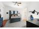 Bedroom with neutral colored walls, ceiling fan, wood floors, and ensuite bathroom at 4110 Highland Park Cir, Lutz, FL 33558