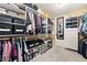 Organized walk-in closet with custom shelving, racks, and a full-length mirror at 4110 Highland Park Cir, Lutz, FL 33558