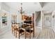 Bright breakfast nook with a modern chandelier, views of the kitchen, and light wood floors at 4110 Highland Park Cir, Lutz, FL 33558