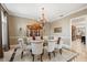 Elegant dining room features a decorative chandelier, custom floor design, and display cabinet at 4110 Highland Park Cir, Lutz, FL 33558