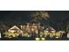 Night view of elegant home exterior with beautiful architectural detail and landscape lighting at 4110 Highland Park Cir, Lutz, FL 33558