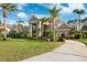 Impressive home with grand columns, mature landscaping, and a circular driveway at 4110 Highland Park Cir, Lutz, FL 33558