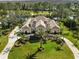 Stunning two-story home with a manicured lawn, circle driveway, and lush landscaping at 4110 Highland Park Cir, Lutz, FL 33558