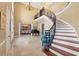 Expansive foyer with high ceilings, elegant staircase, marble floors, and open view to the dining area at 4110 Highland Park Cir, Lutz, FL 33558