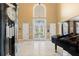 Grand foyer featuring soaring ceilings, marble floors, a striking staircase, and an elegant piano at 4110 Highland Park Cir, Lutz, FL 33558