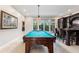 Well-lit game room featuring a pool table, bar, and elegant details at 4110 Highland Park Cir, Lutz, FL 33558