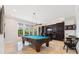 Entertaining game room with a pool table, wet bar, and natural light at 4110 Highland Park Cir, Lutz, FL 33558