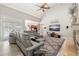 Inviting living room with a fireplace, vaulted ceiling, large windows, and comfortable seating at 4110 Highland Park Cir, Lutz, FL 33558