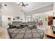Open-concept living room with vaulted ceilings, a fireplace, and a seamless flow to the kitchen at 4110 Highland Park Cir, Lutz, FL 33558