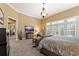 Relaxing main bedroom featuring a sitting area, a TV, and French doors with white shutters at 4110 Highland Park Cir, Lutz, FL 33558