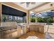 Outdoor kitchen featuring stainless steel grill, sink, refrigerator and views of screened pool area at 4110 Highland Park Cir, Lutz, FL 33558