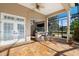 Inviting outdoor kitchen features a bar area, ceiling fan, travertine floor and access to a screened lanai at 4110 Highland Park Cir, Lutz, FL 33558