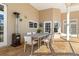Outdoor dining area with a modern table, comfortable chairs, and access to the pool area at 4110 Highland Park Cir, Lutz, FL 33558