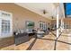 Relaxing covered patio with fire pit, comfortable seating, and travertine flooring at 4110 Highland Park Cir, Lutz, FL 33558