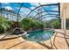 Backyard pool with a rock waterfall and screened lanai, offering a private outdoor oasis at 4110 Highland Park Cir, Lutz, FL 33558