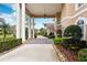 Covered entrance featuring stone pavers and manicured greenery at 4110 Highland Park Cir, Lutz, FL 33558