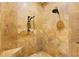 Walk-in shower featuring travertine tile, dual shower heads, and a built-in bench at 4110 Highland Park Cir, Lutz, FL 33558