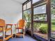 Enclosed sunroom with plush blue carpeting and comfortable seating, perfect for relaxation and enjoying the outdoor views at 423 Windrush Bay Dr, Tarpon Springs, FL 34689