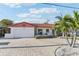 Charming single-story home with a red tile roof, an attached garage, and a neatly paved driveway at 619 59Th Ave, St Pete Beach, FL 33706