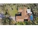Aerial view showcasing the home's roof, pool, backyard, landscaping, and surrounding neighborhood at 6524 Coronet Dr, New Port Richey, FL 34655