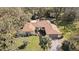 Aerial shot of a home surrounded by lush trees, featuring a swimming pool and a spacious backyard at 6524 Coronet Dr, New Port Richey, FL 34655