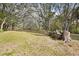 Lush backyard with mature trees, creating a serene and private outdoor space at 6524 Coronet Dr, New Port Richey, FL 34655