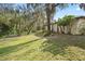 Expansive backyard featuring mature trees and lush greenery providing a serene and private setting at 6524 Coronet Dr, New Port Richey, FL 34655