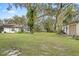 Expansive backyard with mature trees provides ample space for outdoor activities and relaxation at 6524 Coronet Dr, New Port Richey, FL 34655