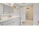 Well-lit bathroom features a white vanity, stylish fixtures, and a shower-tub combination at 6524 Coronet Dr, New Port Richey, FL 34655