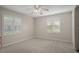 Spacious bedroom offering neutral walls, large windows, carpet flooring, and ceiling fan at 6524 Coronet Dr, New Port Richey, FL 34655