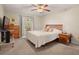 Cozy bedroom features a ceiling fan, neutral walls, and access to an outdoor patio at 6524 Coronet Dr, New Port Richey, FL 34655