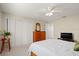 Comfortable bedroom with white trim, closet with double doors, and ceiling fan at 6524 Coronet Dr, New Port Richey, FL 34655