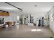 Spacious garage with storage cabinets, water equipment, and access to laundry room at 6524 Coronet Dr, New Port Richey, FL 34655