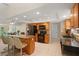Open kitchen featuring an island with seating, wooden cabinets, and modern appliances at 6524 Coronet Dr, New Port Richey, FL 34655