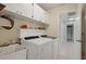 Convenient laundry room with white cabinets, utility sink, and washer and dryer at 6524 Coronet Dr, New Port Richey, FL 34655