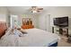 Comfortable primary bedroom featuring a king bed and a large television, offering a relaxing retreat at 6524 Coronet Dr, New Port Richey, FL 34655