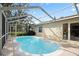Relaxing screened-in pool area is perfect for enjoying sunny days in a refreshing and private setting at 6524 Coronet Dr, New Port Richey, FL 34655