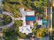Overhead shot of luxurious home, with a long driveway, swimming pool, and meticulously landscaped grounds at 6935 Date Palm S Ave, St Petersburg, FL 33707