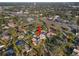 Aerial view of the property showing the home's surroundings, including mature trees and a nearby street at 6935 Date Palm S Ave, St Petersburg, FL 33707