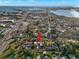 Wide aerial shot featuring the property amidst lush trees, cityscape, and serene bay views beyond at 6935 Date Palm S Ave, St Petersburg, FL 33707