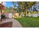 Inviting backyard with a brick pathway, grill and plenty of greenery at 6935 Date Palm S Ave, St Petersburg, FL 33707