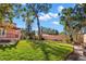 Expansive backyard showcases lush lawn and mature trees, offering ample space for outdoor activities at 6935 Date Palm S Ave, St Petersburg, FL 33707